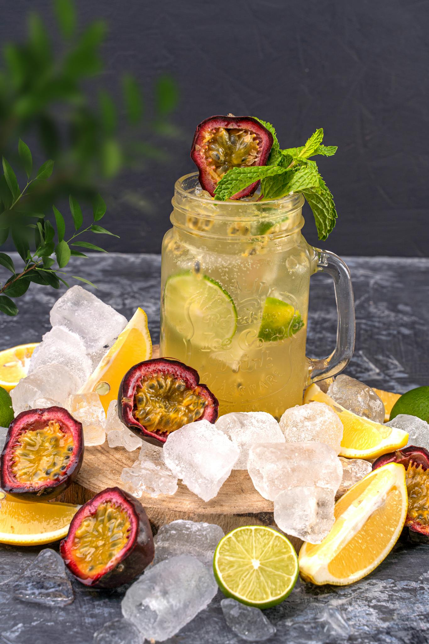 Chilled citrus and passion fruit mocktail adorned with ice, mint, and fresh slices, perfect for a summer refreshment.
